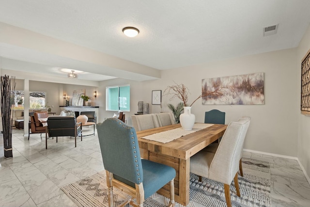 dining area featuring a textured ceiling