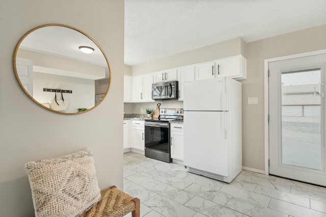 kitchen featuring appliances with stainless steel finishes and white cabinetry