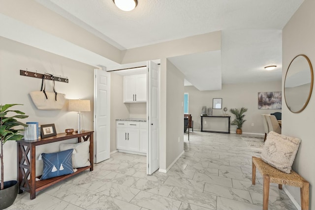 hallway with a textured ceiling