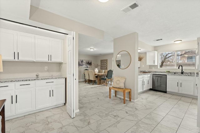 kitchen featuring light stone counters, sink, dishwasher, and white cabinetry