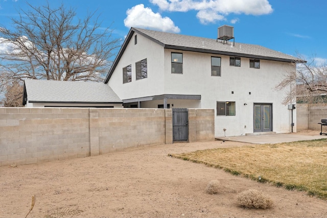 rear view of property featuring a patio and a lawn