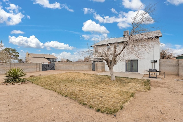 rear view of property with a patio area and a yard