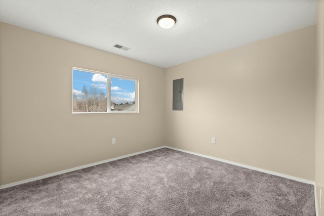 carpeted empty room with electric panel