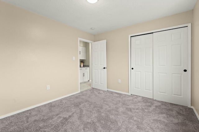 unfurnished bedroom with a closet and light carpet