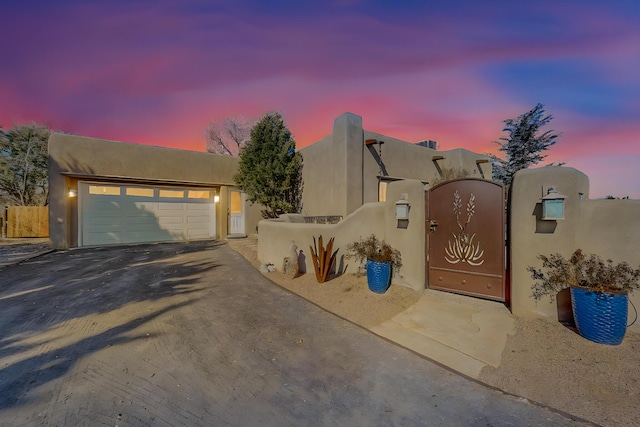 adobe home featuring a garage