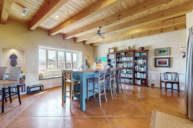 tiled dining space featuring beamed ceiling, ceiling fan, and wooden ceiling