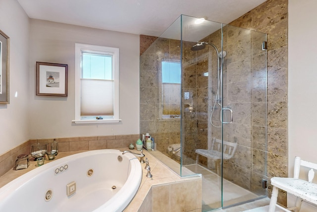 bathroom featuring separate shower and tub