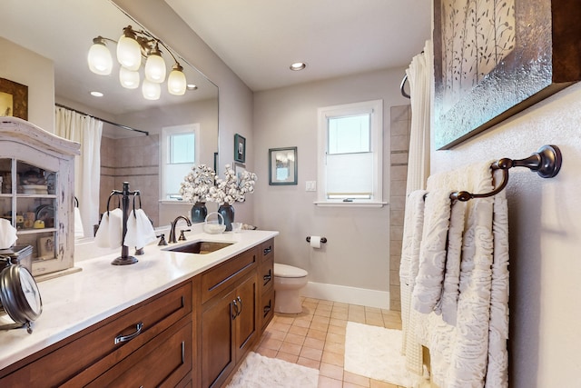 bathroom featuring toilet, vanity, tile patterned floors, and walk in shower