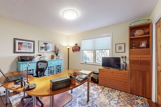 office space featuring hardwood / wood-style flooring and a textured ceiling