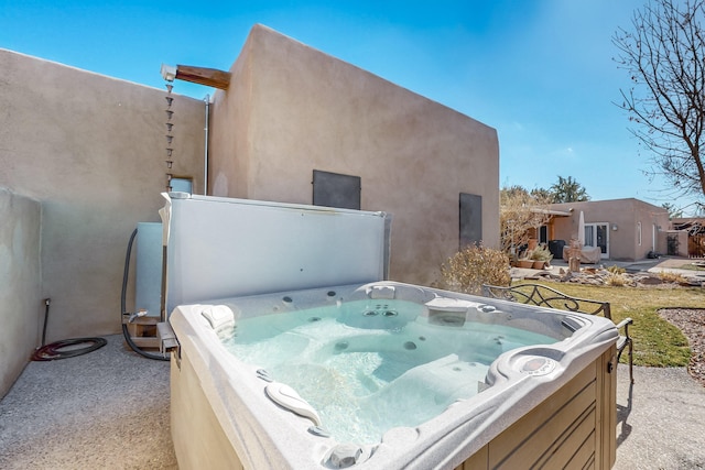 exterior space featuring a hot tub