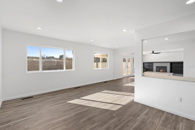 unfurnished living room with hardwood / wood-style floors and a fireplace