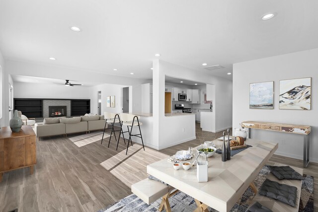 unfurnished living room with ceiling fan and hardwood / wood-style flooring