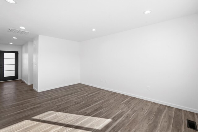 unfurnished living room featuring ceiling fan, dark hardwood / wood-style floors, and a fireplace