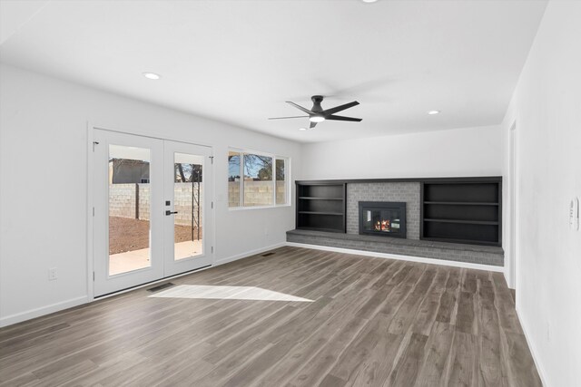 unfurnished living room featuring ceiling fan and dark hardwood / wood-style flooring