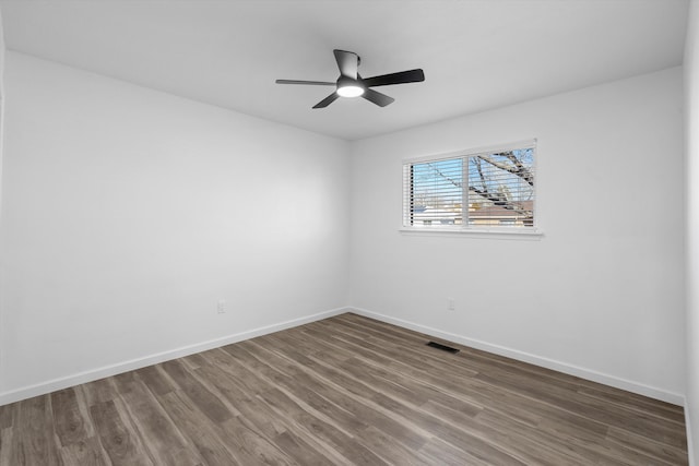 empty room featuring ceiling fan and dark hardwood / wood-style floors