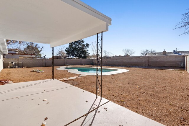 view of swimming pool featuring a diving board