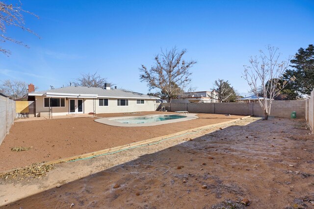 view of swimming pool with a diving board