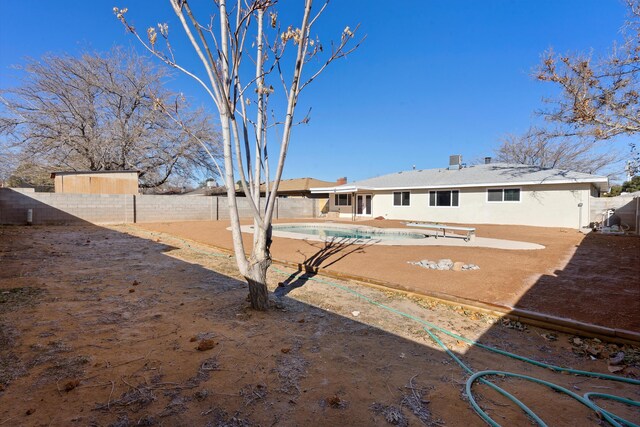 view of pool featuring a diving board and central AC unit