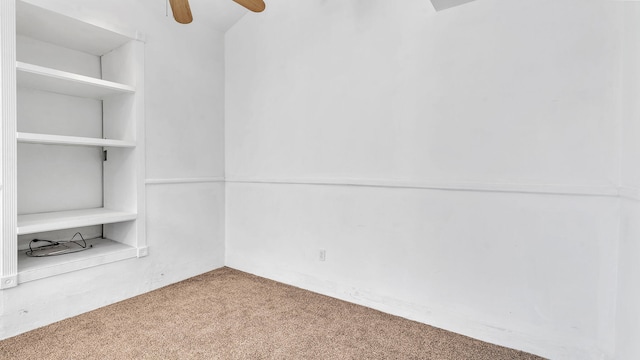 spare room with ceiling fan and carpet