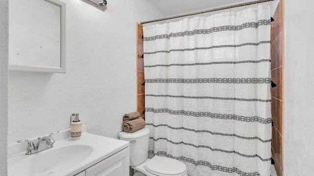 bathroom with toilet, a shower with shower curtain, and vanity