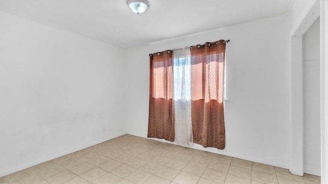 empty room featuring baseboards