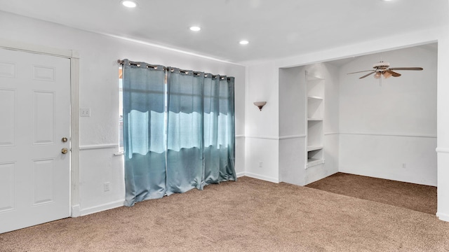 carpeted spare room with built in features, recessed lighting, and ceiling fan