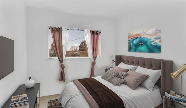 bedroom with light tile patterned floors