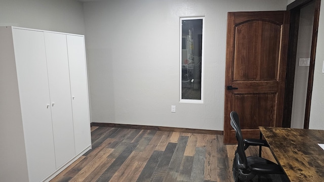 home office with dark wood-type flooring