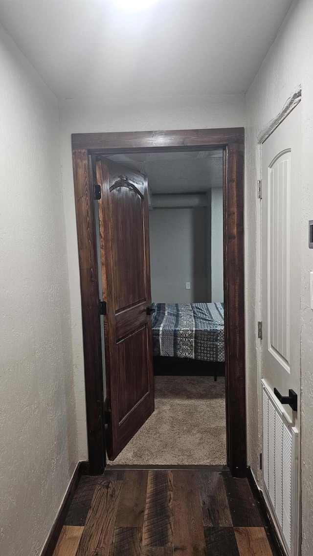 corridor featuring dark hardwood / wood-style flooring