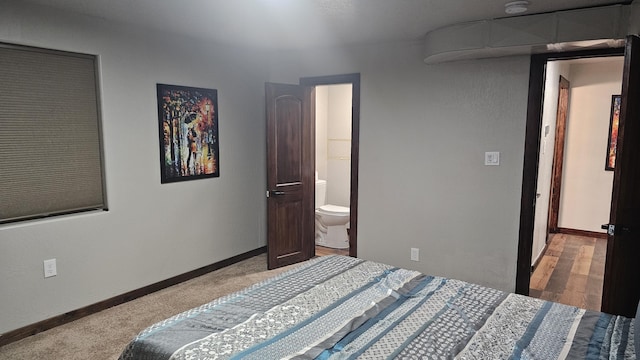 bedroom with carpet floors and connected bathroom