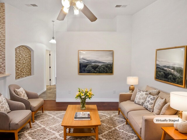 living room with ceiling fan and hardwood / wood-style flooring