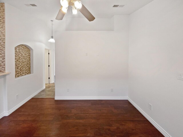 spare room with ceiling fan and dark hardwood / wood-style flooring