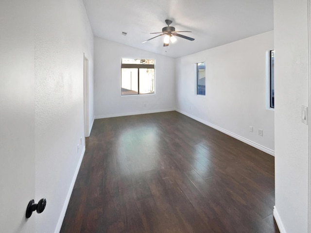 spare room with ceiling fan, dark wood-type flooring, and lofted ceiling