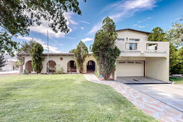 mediterranean / spanish-style house with a balcony, a front lawn, and a garage