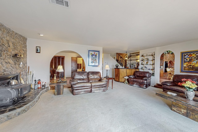 living room featuring carpet and a wood stove