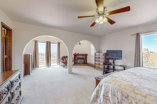 carpeted bedroom with ceiling fan and access to outside