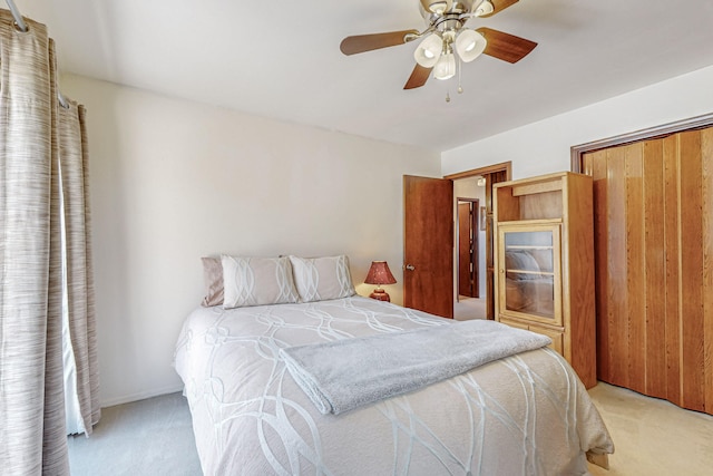 bedroom featuring ceiling fan, a closet, and light colored carpet