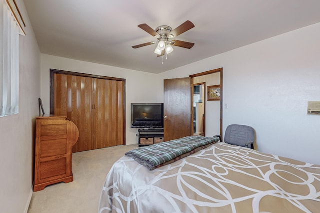 carpeted bedroom with ceiling fan and a closet