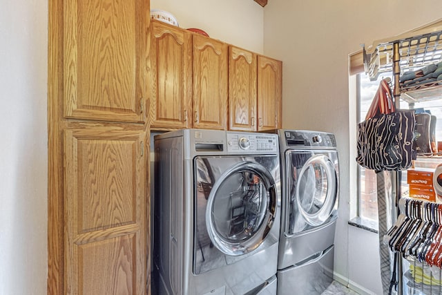 laundry room with cabinets and separate washer and dryer