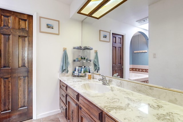 bathroom featuring tile patterned flooring, vanity, and a bathtub