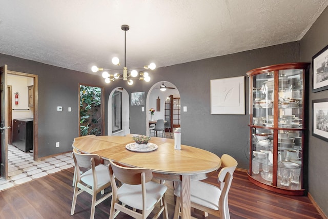 dining room with an inviting chandelier, hardwood / wood-style floors, and a textured ceiling