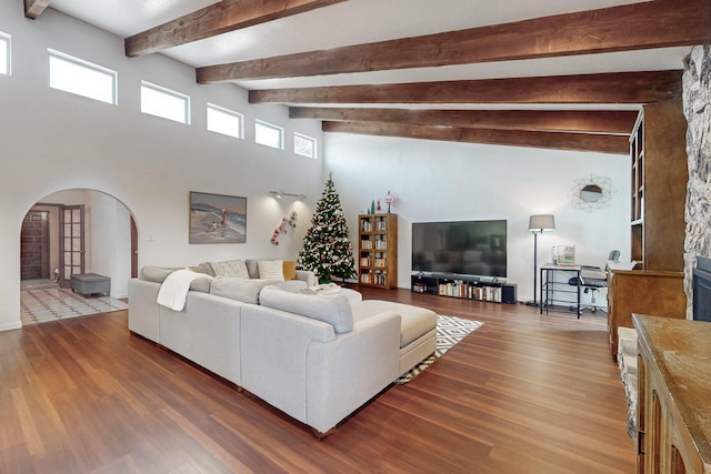 living room featuring dark hardwood / wood-style flooring and beam ceiling