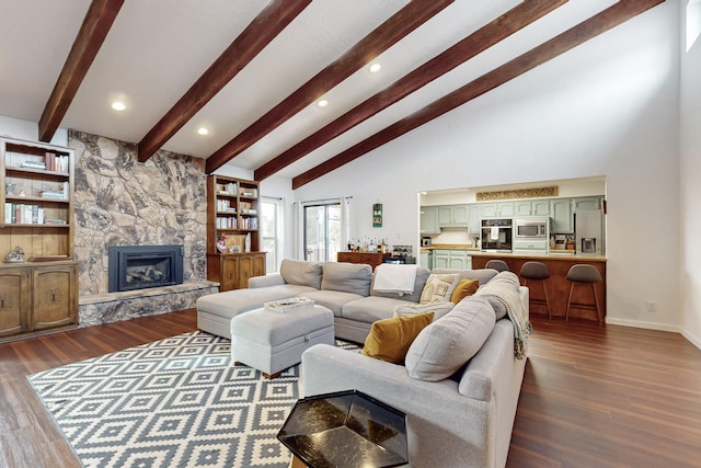 living room featuring beamed ceiling, dark hardwood / wood-style flooring, a high ceiling, and a fireplace