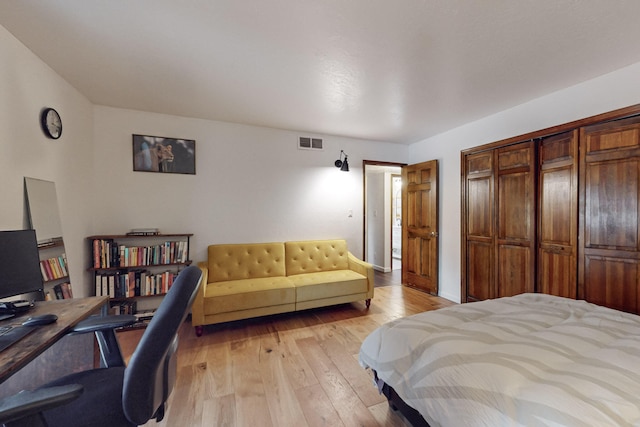 bedroom featuring light hardwood / wood-style flooring and a closet