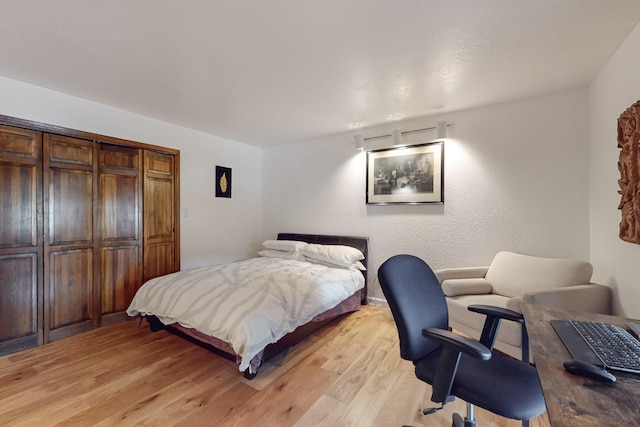 bedroom featuring light hardwood / wood-style floors and a closet