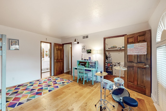 rec room with light hardwood / wood-style flooring