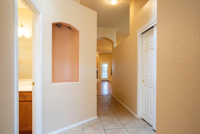 corridor featuring light tile patterned flooring