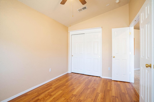 unfurnished bedroom with vaulted ceiling, ceiling fan, light hardwood / wood-style floors, and a closet