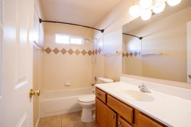 full bathroom featuring tiled shower / bath, vanity, tile patterned floors, and toilet