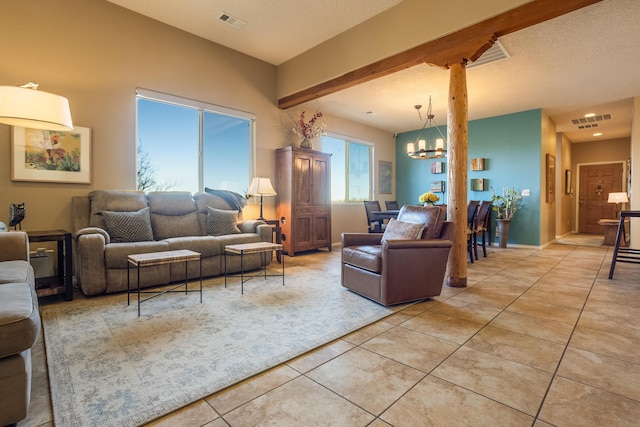 living room featuring light tile patterned floors, a chandelier, and a textured ceiling